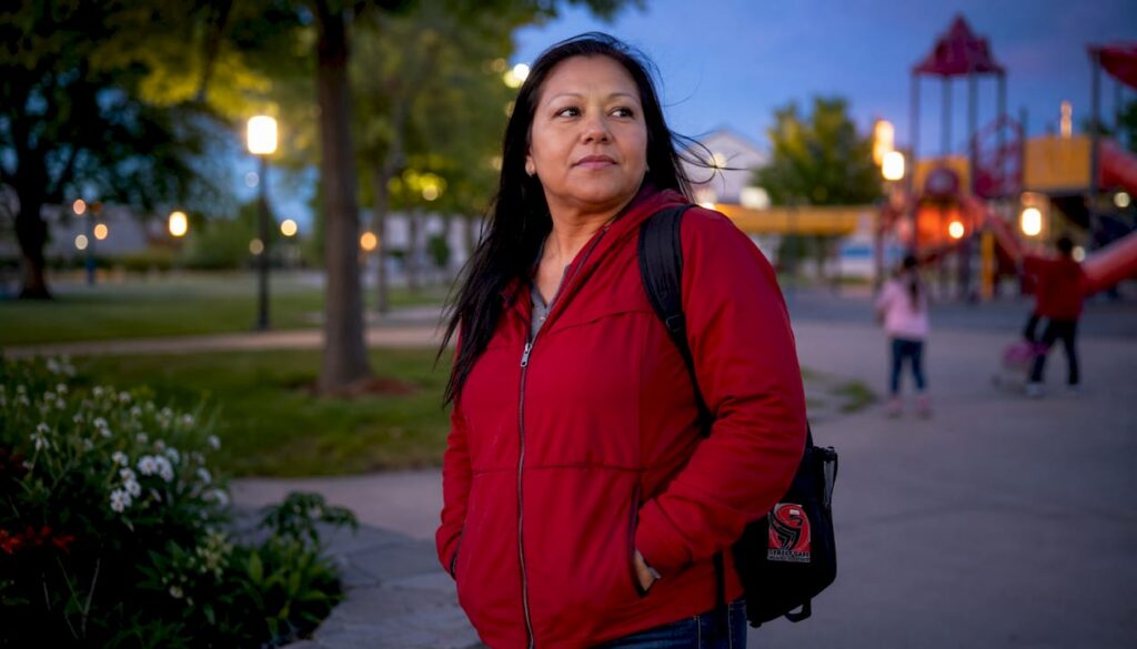 Woman practicing situational awareness while scanning an urban parking lot environment