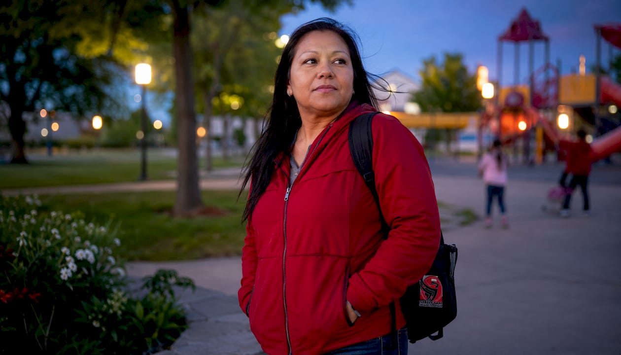 Woman practicing situational awareness while scanning an urban parking lot environment