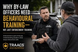 A municipal By-Law Officer speaks with a resident during a neighbourhood enforcement call, illustrating the importance of behavioural awareness, communication, and workplace violence prevention through the TRAACS training system.
