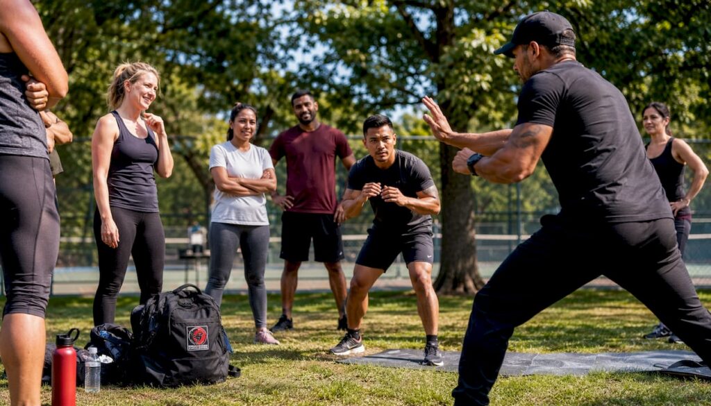Group learning self-defence techniques in gym