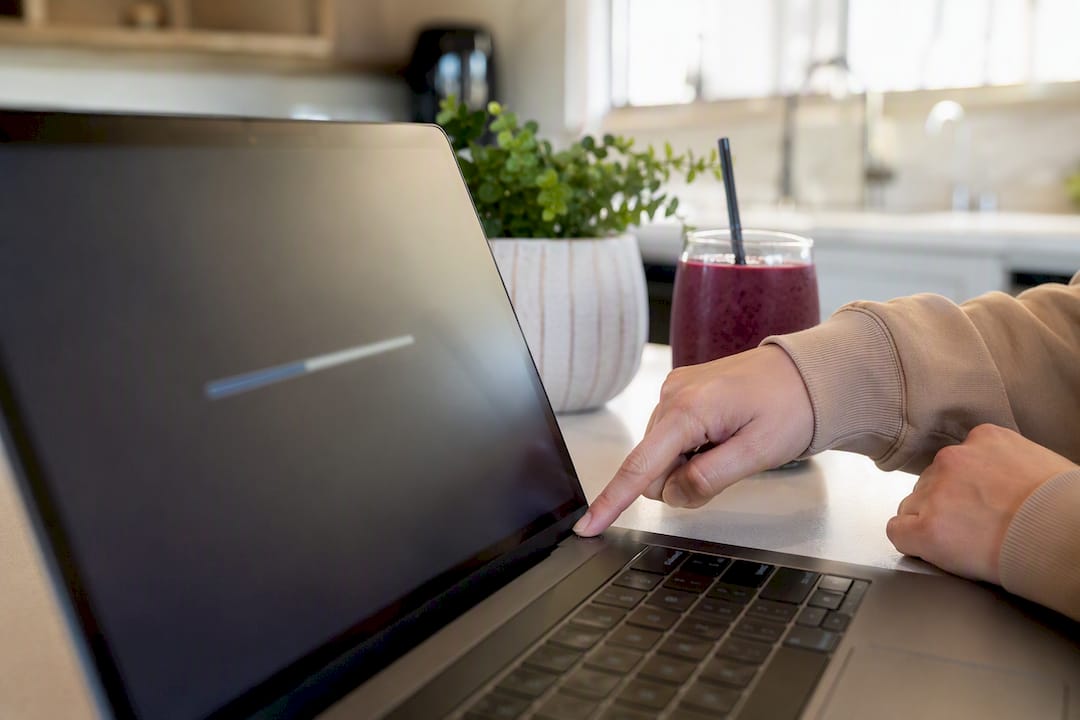 Hands rebooting laptop during software update