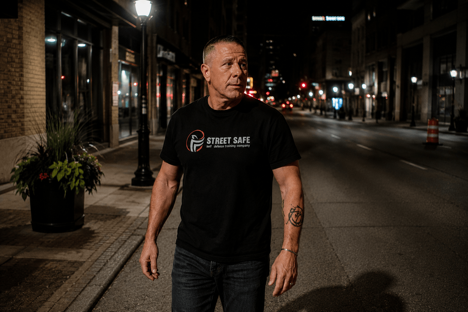 Rob Andress of Street Safe Self Defence demonstrating situational awareness and threat recognition while walking on a city street at night.